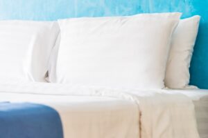 4 pillows on a neatly made bed