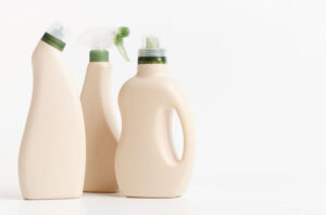 3 bottles of laundry cleaning products with green tops