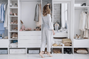 Woman standing in front of a large organized closet
