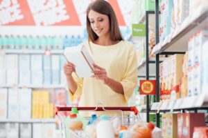 woman grocery shopping in the cleaning and detergent aisle